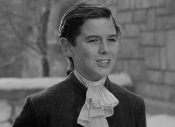 Movie still from “A Christmas Carol” (1938), directed by Edwin L. Marin – A young man wearing a jacket and a bow tie; Close Up shot, High angle