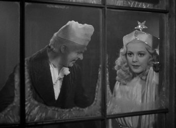 Movie still from “A Christmas Carol” (1938), directed by Edwin L. Marin – A black and white photo of a man and a woman; Medium shot, Over the shoulder angle