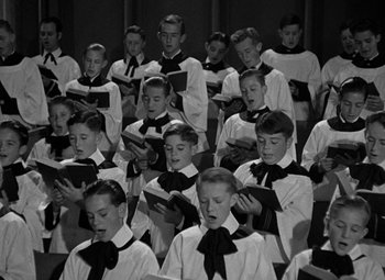 Movie still from “A Christmas Carol” (1938), directed by Edwin L. Marin – A group of young men in white shirts and black ties; Medium shot, High angle