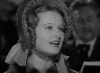 Movie still from “A Christmas Carol” (1938), directed by Edwin L. Marin – A woman wearing a fur hat and a scarf; Close Up shot, High angle