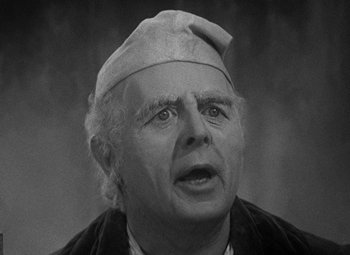 Movie still from “A Christmas Carol” (1938), directed by Edwin L. Marin – An older man wearing a hat and looking surprised; Close Up shot, High angle
