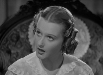 Movie still from “A Christmas Carol” (1938), directed by Edwin L. Marin – A black and white photo of a woman with a lot of hair in her hair; Close Up shot, High angle
