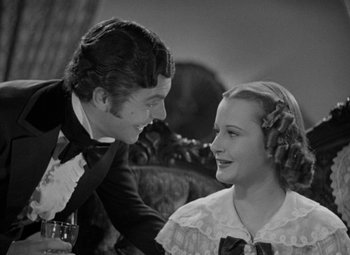 Movie still from “A Christmas Carol” (1938), directed by Edwin L. Marin – A man and a woman sitting next to each other; Close Up shot, High angle