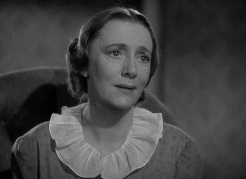 Movie still from “A Christmas Carol” (1938), directed by Edwin L. Marin – An old photo of a woman looking at the camera; Close Up shot, High angle