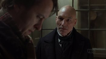 Movie still from “A Christmas Carol” (1999), directed by David Hugh Jones – A man in a suit and tie looking at another man; Close Up shot, Over the shoulder angle