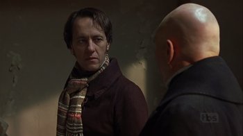 Movie still from “A Christmas Carol” (1999), directed by David Hugh Jones – A man wearing a scarf looking into a mirror; Close Up shot, Over the shoulder angle