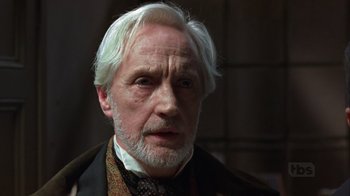 Movie still from “A Christmas Carol” (1999), directed by David Hugh Jones – An older man with white hair wearing a suit and tie; Close Up shot, Low angle