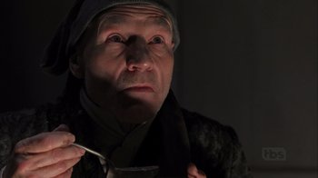 Movie still from “A Christmas Carol” (1999), directed by David Hugh Jones – An older man with a hat and a scarf on; Close Up shot, Low angle