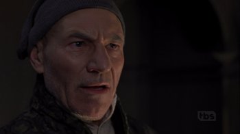 Movie still from “A Christmas Carol” (1999), directed by David Hugh Jones – An older man wearing a hat and a jacket; Close Up shot, Over the shoulder angle