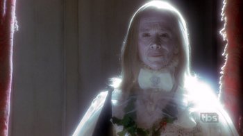 Movie still from “A Christmas Carol” (1999), directed by David Hugh Jones – An old woman wearing a white dress and a bow tie; Close Up shot, Low angle