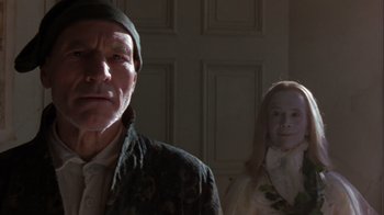 Movie still from “A Christmas Carol” (1999), directed by David Hugh Jones – A man and a woman standing next to each other in a room; Close Up shot, Low angle