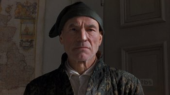 Movie still from “A Christmas Carol” (1999), directed by David Hugh Jones – An older man wearing a hat in a room; Close Up shot, Low angle