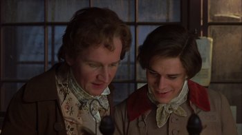 Movie still from “A Christmas Carol” (1999), directed by David Hugh Jones – Two men in period clothing looking at each other; Close Up shot, High angle