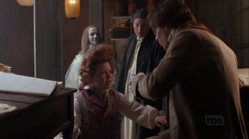 Movie still from “A Christmas Carol” (1999), directed by David Hugh Jones – A young girl is shaking hands with an older man; Medium shot, Over the shoulder angle