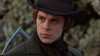 Movie still from “A Christmas Carol” (1999), directed by David Hugh Jones – A young man in a black hat and a black coat; Close Up shot, Low angle