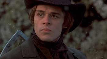 Movie still from “A Christmas Carol” (1999), directed by David Hugh Jones – A young man in a black hat and a black jacket; Close Up shot, Low angle