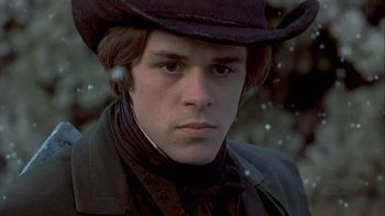 Movie still from “A Christmas Carol” (1999), directed by David Hugh Jones – A young man wearing a black hat and a black jacket; Close Up shot, Low angle