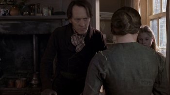 Movie still from “A Christmas Carol” (1999), directed by David Hugh Jones – A man and a woman are talking in a room; Medium shot, Over the shoulder angle