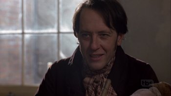 Movie still from “A Christmas Carol” (1999), directed by David Hugh Jones – A person wearing a jacket; Close Up shot, Over the shoulder angle