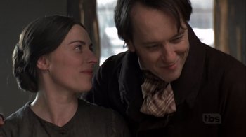 Movie still from “A Christmas Carol” (1999), directed by David Hugh Jones – A man and a woman smiling for the camera; Close Up shot, Over the shoulder angle