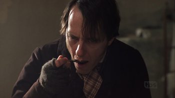 Movie still from “A Christmas Carol” (1999), directed by David Hugh Jones – A man in a suit and tie holding a toothbrush in his mouth; Close Up shot, High angle
