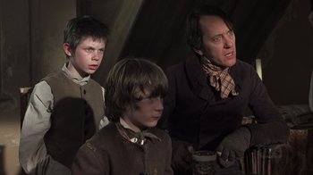 Movie still from “A Christmas Carol” (1999), directed by David Hugh Jones – A group of young boys and an older man; Medium shot, Low angle