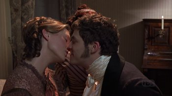 Movie still from “A Christmas Carol” (1999), directed by David Hugh Jones – A man and a woman kissing each other in front of a wall; Close Up shot, Over the shoulder angle