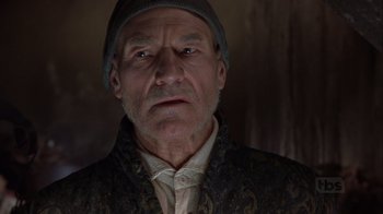 Movie still from “A Christmas Carol” (1999), directed by David Hugh Jones – An older man wearing a hat and a jacket; Close Up shot, Low angle