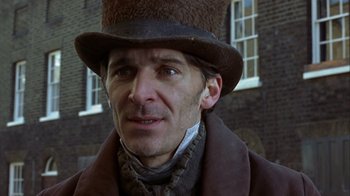 Movie still from “A Christmas Carol” (1999), directed by David Hugh Jones – A person wearing a hat; Close Up shot, Low angle