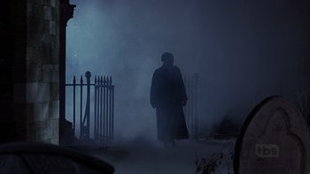 Movie still from “A Christmas Carol” (1999), directed by David Hugh Jones – A man in a long coat walking in the fog; Wide shot, Low angle