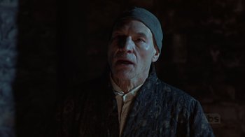 Movie still from “A Christmas Carol” (1999), directed by David Hugh Jones – An older man wearing a hat and a jacket; Close Up shot, Low angle
