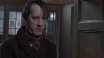 Movie still from “A Christmas Carol” (1999), directed by David Hugh Jones – A man in a brown coat and a red tie; Close Up shot, Low angle