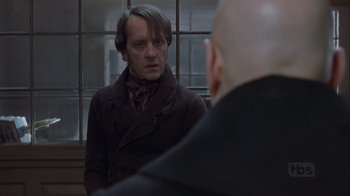 Movie still from “A Christmas Carol” (1999), directed by David Hugh Jones – A man is looking at another man in front of a window; Close Up shot, Over the shoulder angle