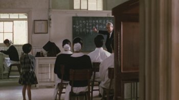 Movie still from “A City of Sadness” (1989), directed by Hsiao-Hsien Hou – A group of people sitting in front of a chalkboard; Wide shot, Over the shoulder angle