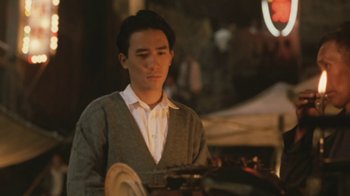 Movie still from “A City of Sadness” (1989), directed by Hsiao-Hsien Hou – A man in a white shirt and a gray sweater; Medium shot, Low angle
