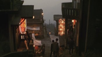 Movie still from “A City of Sadness” (1989), directed by Hsiao-Hsien Hou – A group of people walking down a street at night; Extreme Wide shot, High angle