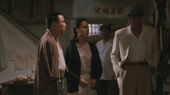 Movie still from “A City of Sadness” (1989), directed by Hsiao-Hsien Hou – A group of men and women standing next to each other; Medium shot, Over the shoulder angle