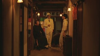 Movie still from “A City of Sadness” (1989), directed by Hsiao-Hsien Hou – A group of men standing in a hallway; Wide shot, Low angle