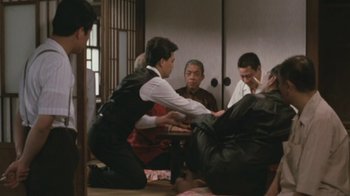 Movie still from “A City of Sadness” (1989), directed by Hsiao-Hsien Hou – A group of people sitting around a room; Wide shot, Over the shoulder angle