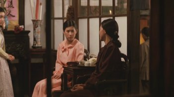 Movie still from “A City of Sadness” (1989), directed by Hsiao-Hsien Hou – Two women sitting at a table talking to each other; Medium shot, Over the shoulder angle