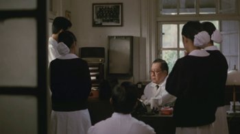 Movie still from “A City of Sadness” (1989), directed by Hsiao-Hsien Hou – A group of people standing in a room; Medium shot, Over the shoulder angle