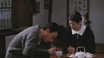 Movie still from “A City of Sadness” (1989), directed by Hsiao-Hsien Hou – A man and a woman sitting at a dining table; Medium shot, High angle
