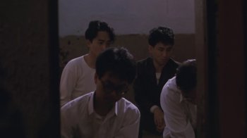 Movie still from “A City of Sadness” (1989), directed by Hsiao-Hsien Hou – A group of young men sitting next to each other in a room; Medium shot, High angle