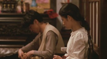 Movie still from “A City of Sadness” (1989), directed by Hsiao-Hsien Hou – A man and a woman sitting at a table; Medium shot, Over the shoulder angle