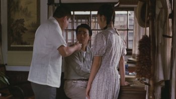 Movie still from “A City of Sadness” (1989), directed by Hsiao-Hsien Hou – A man and two women talking to each other in front of a window; Medium shot, Over the shoulder angle