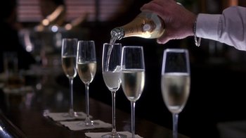 Movie still from “A Civil Action” (1998), directed by Steven Zaillian – A person is pouring champagne into a row of champagne glasses; Extreme Close Up shot, Low angle