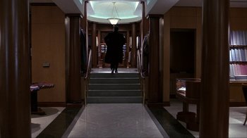 Movie still from “A Civil Action” (1998), directed by Steven Zaillian – A man walking down the stairs of a building; Wide shot, High angle