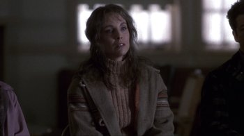 Movie still from “A Civil Action” (1998), directed by Steven Zaillian – A woman wearing a sweater and a coat; Close Up shot, Over the shoulder angle