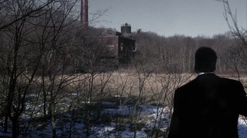 Movie still from “A Civil Action” (1998), directed by Steven Zaillian – An old factory building in the middle of a field; Medium shot, Over the shoulder angle