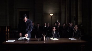 Movie still from “A Civil Action” (1998), directed by Steven Zaillian – A group of men in suits sitting at a table in a courtroom; Wide shot, High angle